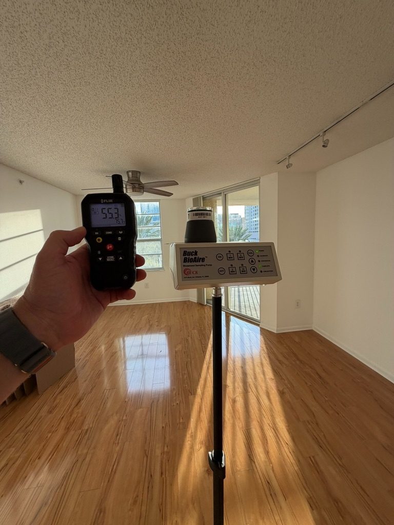 Air sampling pump and hygrometer positioned in the main living area during indoor air quality testing.