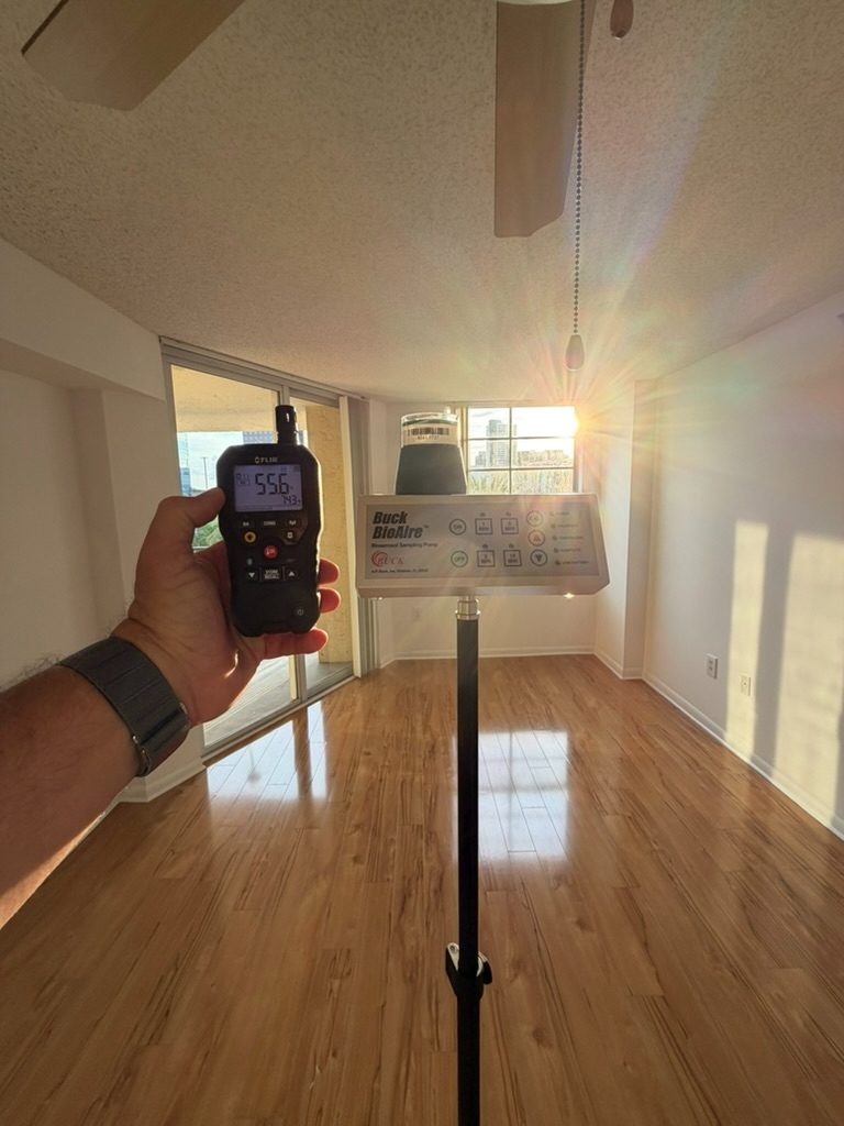 Air sampling pump collecting an indoor air sample near the living area windows.