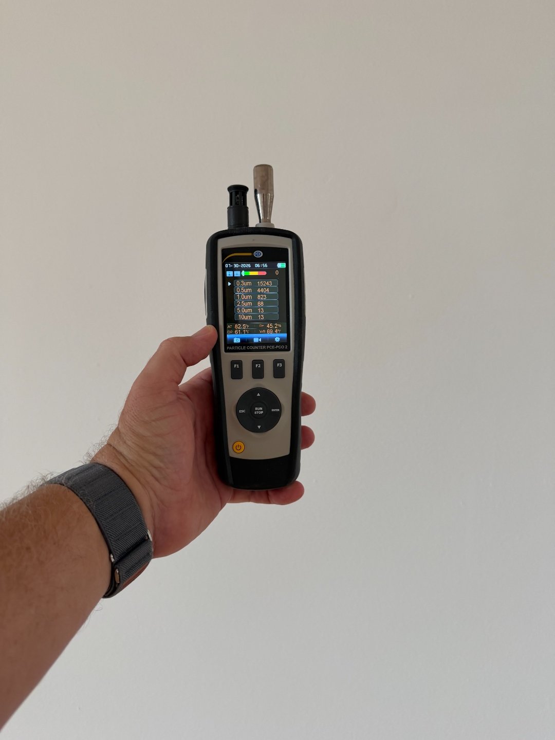 Particle counter measuring airborne particulate concentrations during the indoor air quality assessment.