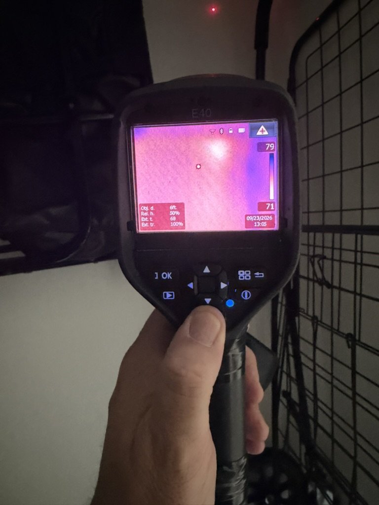 FLIR E40 thermal imaging camera scanning a surface inside a closet.